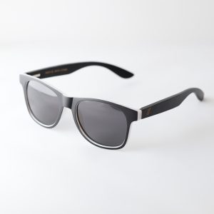 Bambook sunglasses with matte black and white frames; the lenses are dark grey. Designed in Canada