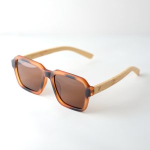 Carpathia bamboo sunglasses opened on a white background, with tortie frame, brown lenses and light brown natural bamboo arms.