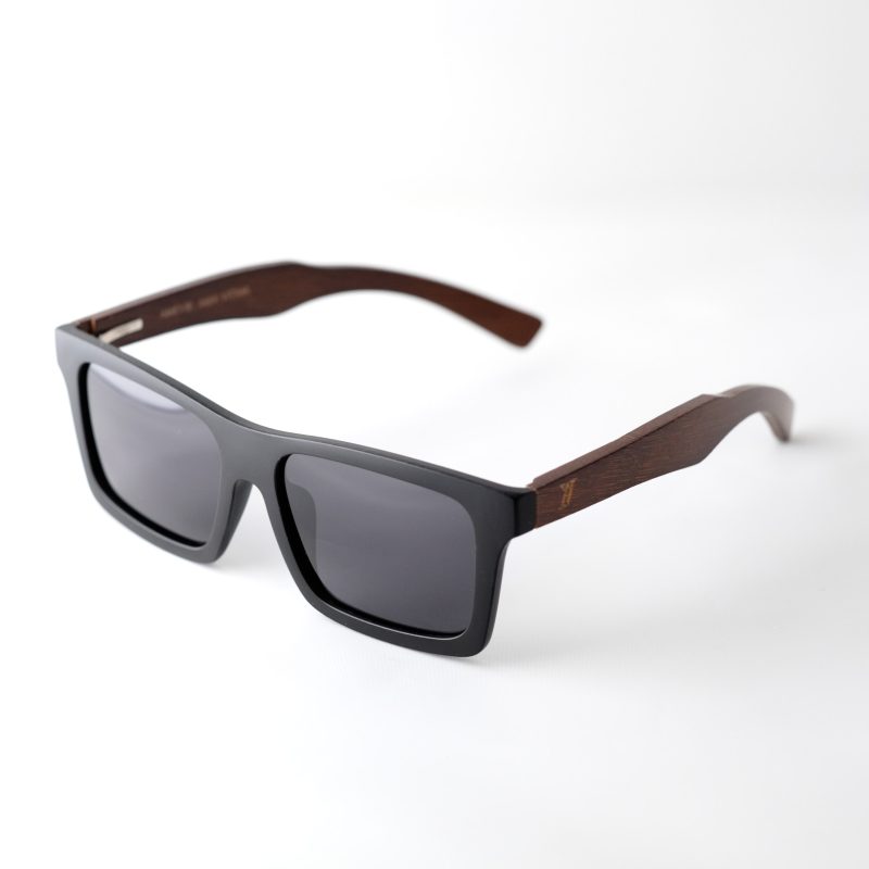 bamboo sunglasses on white background, with brown arms and matte black frames. Smokey dark grey lenses. Designed in Canada